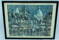 Framed Maurice Legendre art showing Paris Place Du Tertre street scene with building facades, people and the dome of Sacré-Cœur in background.