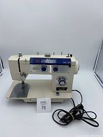 Front and side view of the Nelco Jolson 293 sewing machine showing overall design, stitch pattern options and knobs.