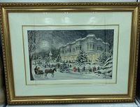 Framed winter scene wall art showing horse-drawn sleigh, skaters, and Victorian building.