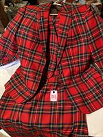 Red Royal Stewart tartan suit pieces including blazer jacket, vest, and skirt shown together