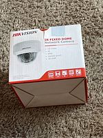 Photo of the first Hikvision IR Fixed Dome Network Camera box showing product image and features