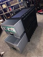 Two stackable filing storage drawers, gray plastic, placed on black plastic base unit, shown from an angle to display size and stack structure