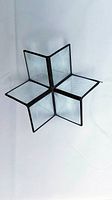 3D star-shaped glass ornament with bevelled edges, showing the overall form and structure.