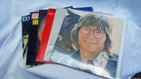Lot of six vinyl records in original sleeves including John Denver, Judy Collins, West Side Story soundtrack, Melanie, and two Elvis Presley albums.