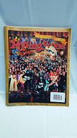 Front view of the Rolling Stone 1000th Issue Special Collector’s Edition magazine showing the colorful lenticular cover featuring many musicians and golden edges.