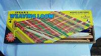 Photo of the original vintage Spear's weaving loom box with colorful tartan design, showing size 4.