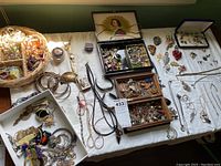 Wide overview of assorted jewelry pieces arranged in baskets, trays and boxes