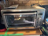 Front view of Black & Decker stainless steel toaster oven on countertop.