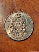 Obverse side of the 1970 Canadian 50 cents coin showing the Royal Coat of Arms with date and denomination