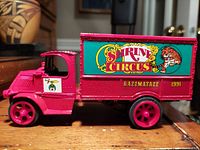 Side view showing bright red die-cast Mack truck with Shrine Circus graphics and 'Razzmatazz 1991' text