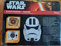 Box front showing Stormtrooper toaster and toasting sample with Galactic Empire logo on both slices along with product features.
