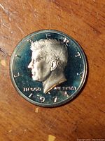 Top-down photo showing obverse side of the 1971 Kennedy Half Dollar coin with Kennedy's profile and date clearly visible