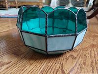 Side view of the teal and white leaded glass bowl showing scalloped edge and lead seams.