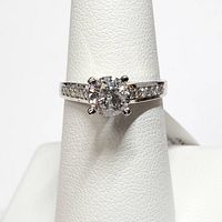 Front view of ring on display stand showing center diamond