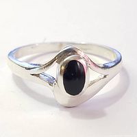 Close-up front view of silver ring with black onyx stone.