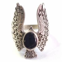 Front view of silver eagle ring with black onyx stone, showcasing detailed wings and central stone.