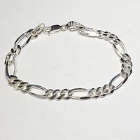 Front view of sterling silver Figaro chain bracelet on white background showing clasp.