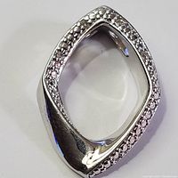 Front view of the marquise-shaped silver pendant showing diamond detailing on the edges.