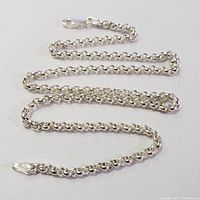 Silver necklace chain laid flat showing the full length and links detail.