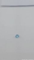 1.91 ct oval cut sky blue topaz on neutral background showing stone's shape and color