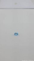 Clear image showing oval cut Swiss blue topaz gemstone from the top angle, highlighting color and clarity.