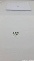Five natural mint green oval cut apatite gemstones arranged on a white background showing size and color.