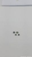 Four natural green sapphires displayed on white background in rectangular emerald cuts with different sizes visible