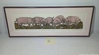 Front view of framed intaglio relief print showing six pigs, signed and numbered by the artist, with clear image of the composition and frame.
