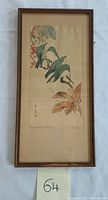 Full view of the framed vertical watercolor painting showing two green birds on a branch with foliage and flowers.