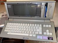 Top view photo of the Brother WP-2200 word processor showing keyboard and screen, function keys and branding.