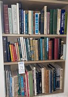 Three shelves of assorted fishing and nature books