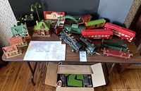 Overview of locomotive, tender, multiple railcars, caboose and curved track crane