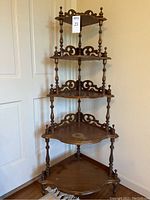 Full view of 5-tier wooden corner stand in corner placement