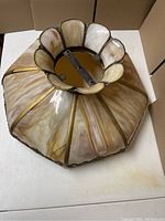 Top-down view of antique slag glass hanging light fixture showing the floral top opening and metal mounting hardware.