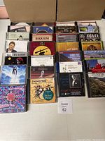 Photo showing a collection of 22 CDs including classical music and other genres arranged in rows with their album covers visible.