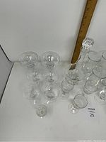 Top-down photo showing the crystal decanter among various stemware glasses with a ruler measuring height in background.