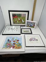 View of six framed artworks including two horses, tropical fish, vintage car, frogs, and small landscape