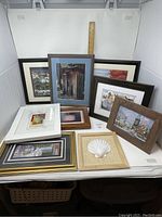 Overview of framed prints and decorative piece arranged together with ruler showing size scale