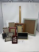 Photo showing entire set of 10 various miscellaneous picture frames in different sizes, materials, and colors, arranged against white background with wooden ruler for scale.