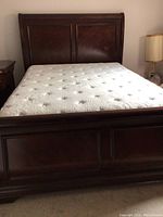 Full frontal view of bed showing headboard, mattress and footboard.