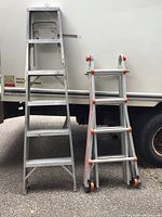 Two ladders side by side against truck