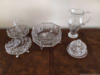 Full view of all five crystal items on wooden surface showing variety and design