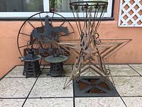 Overview of all items showing three metal lanterns and one metal cowboy welcome sign on tiled surface against an orange wall