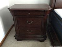 Front view of Broyhill wooden side table showing drawer hardware and top surface
