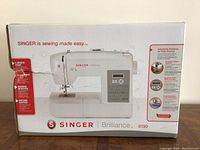 Front view of the Singer Brilliance 6199 sewing machine box showing the machine image and highlights of features.