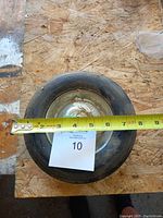 Top view showing one solid rubber wheel measuring approx 8 inches diameter with metal hub.