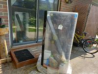 Photo of fish tank wrapped or covered outside on a stand or crate, showing full height and rectangular shape