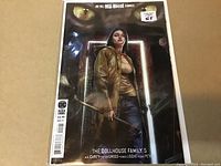 Front cover showing female character holding crowbar with glowing eyes in background