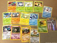 Photo showing 15 rare Pokémon cards arranged on a flat surface including Golbat, Abomasnow, Vileplume, Dewgong, Tropius, Slaking, Ampharos, Wishiwashi, Cobalion, Unown, Rhydon, and a Trainer card.