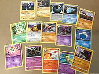 Top view of fifteen rare Pokemon cards laid out on a surface, showing various Pokemon characters with visible text and attack stats.